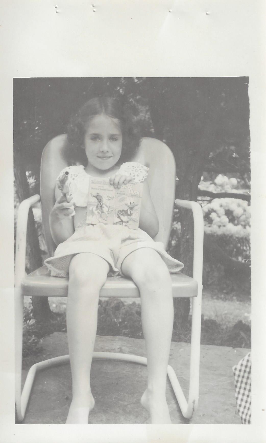 Diane reading a comic book in the garden