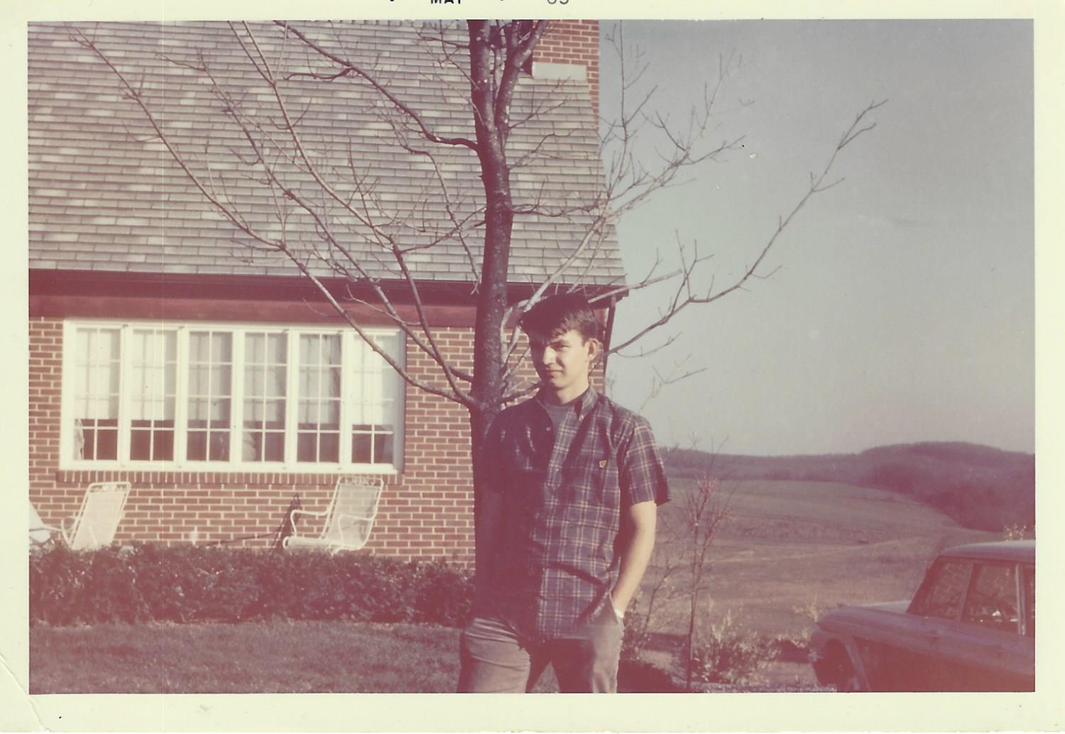 Pete as teenager outside home, c. 1965