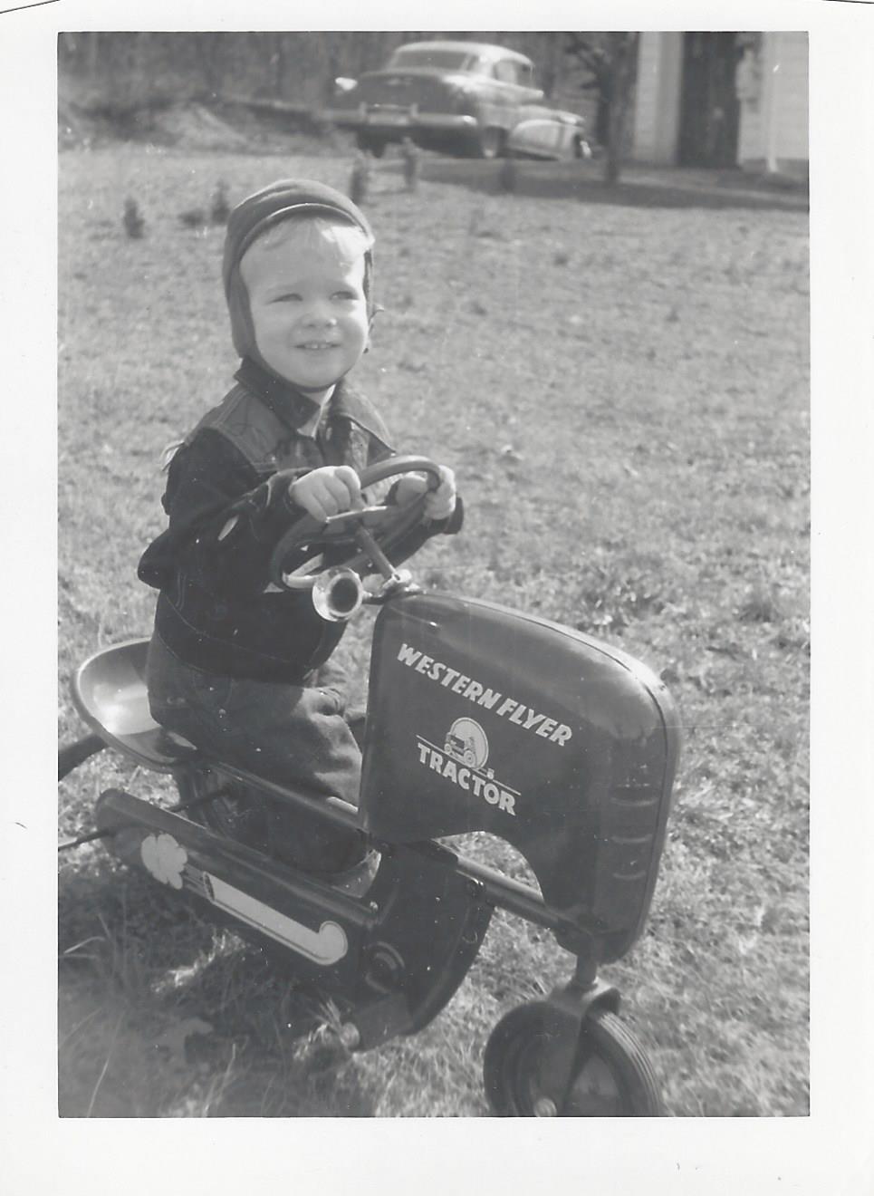 Ralph on pedal tractor, 1950s