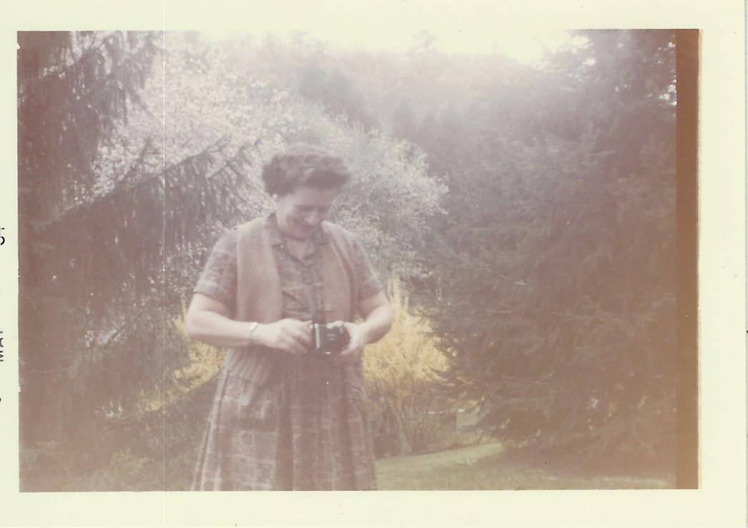 Unknown woman with camera in garden