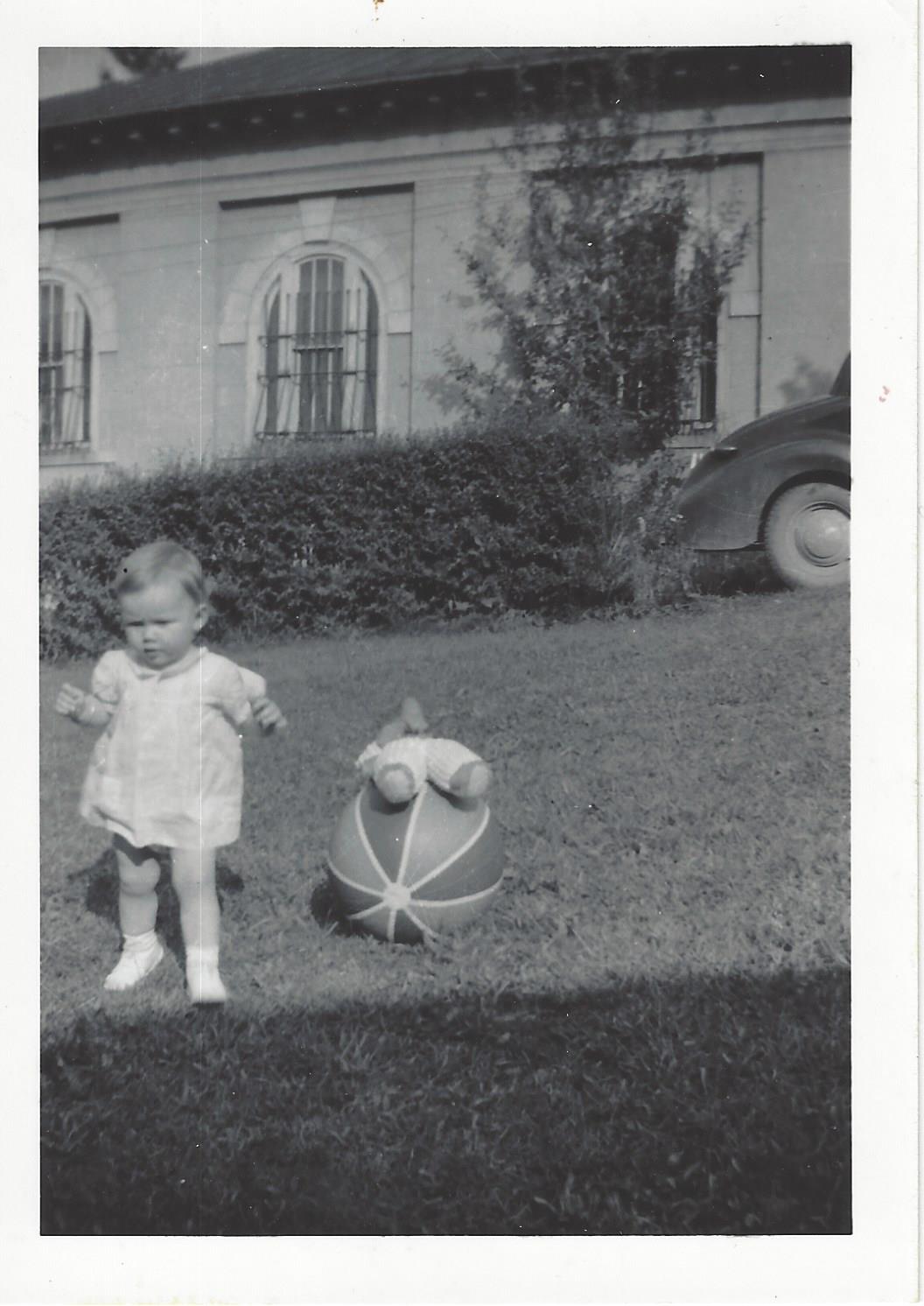 Unknown toddler on lawn